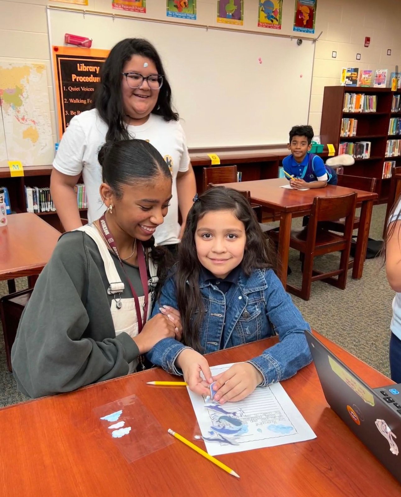 Learn Like Me tutors helping a small group of students with an activity